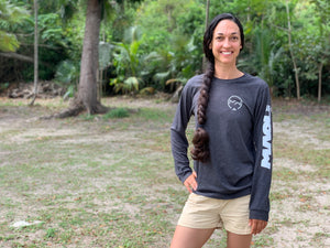 Woman standing in a park with a Maoli long sleeve t-shirt